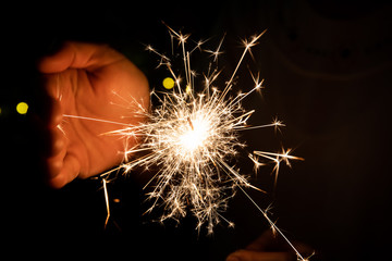 Girl enjoy playing with a small sparkler hand fireworks, celebrating in Christmas and New Year  festival.