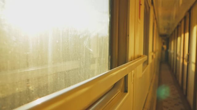 Sunlight trace and flicker inside train corridor, light runs over doors surfaces