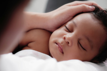 Fototapeta na wymiar portrait of sleeping african american baby girl with mother