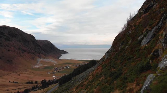 Aerial view of the little village Hoddevik, drone flying close beside a mountain