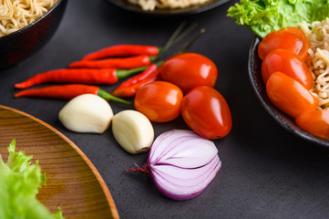 Bright close-up background of red onion slices, garlic, tomato and peppers. Selective focus