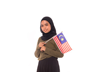 Happy young Malaysian girl holding Malaysia Flag isolated over white background.Independence Day concept.