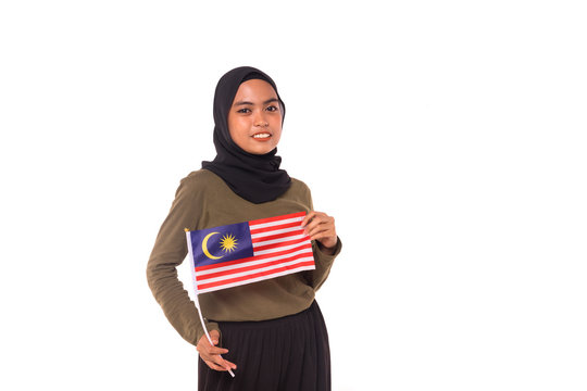 Happy young Malaysian girl holding Malaysia Flag isolated over white background.Independence Day concept.