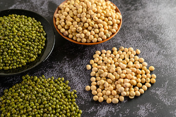 Soybean and Mung bean on a black cement floor background.