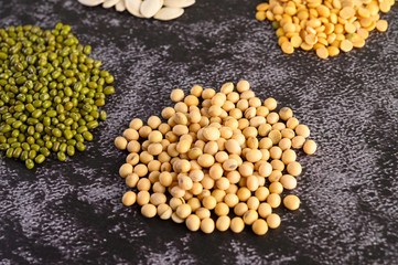 Soybean and Mung bean on a black cement floor background.