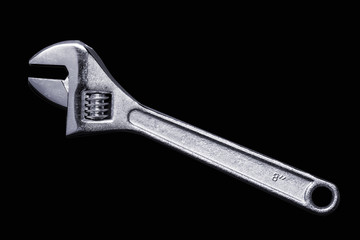 Adjustable wrench stainless steel isolated on black background