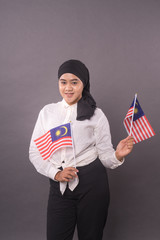 Happy Malaysian Girl holding Malaysia Flag.Independence Day and Patriotic concept studio shot.