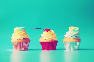 cupcake with icing and sprinkles on white background