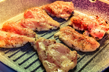 pieces of fried chicken breast. Grilled poultry steak cooked on a grill pan