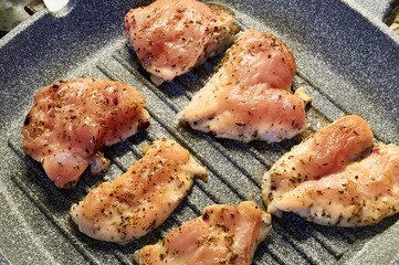 pieces of fried chicken breast. Grilled poultry steak cooked on a grill pan