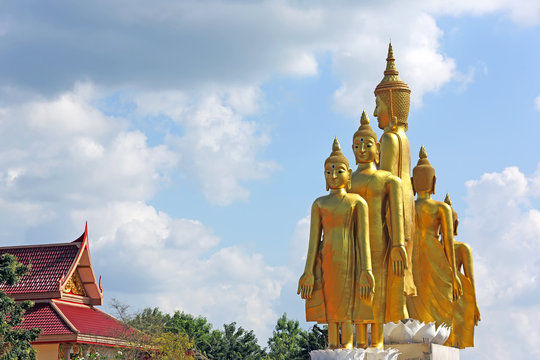 5 golden Buddha statue standing with blue sky background at Mae Ya Som Temple in Sa Kaeo Province of Thailand