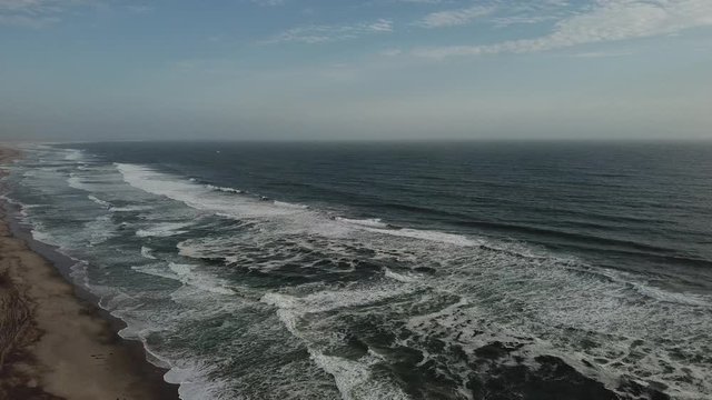 4K aerial drone video view of Namibian Atlantic coastline, Zeila L-758 Walvis Bay stranded rusty shipwreck at sand beach in Skeleton Coast Park landscape with ocean background at Namibia's west coast