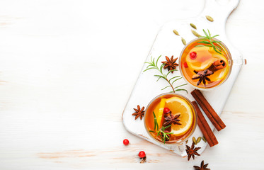 Naklejka na ściany i meble Winter healing hot tea with lemon, cranberries and warming spices, white background, copy space, top view
