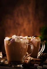 Deurstickers Hot cocoa or chocolate with marshmallow in glass mug and winter decoration on wooden table. Concept of cosy Christmas holidays and New Year, copy space © 5ph