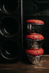 three cupcakes on top of each other on a table with a baking dish