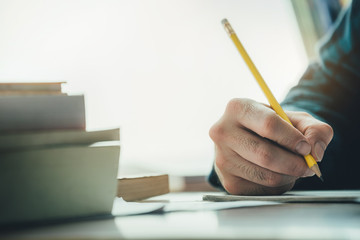 high school,university student study.hands holding pencil writing paper answer sheet.sitting lecture chair taking final exam attending in examination classroom.concept scholarship for education abroad