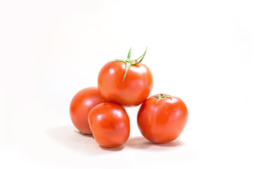 A few tomatoes on a white background.
