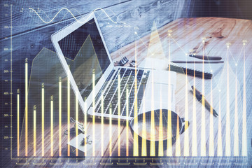 Double exposure of chart and financial info and work space with computer background. Concept of...