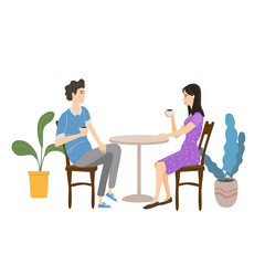 Cute couple sitting at table, drinking tea or coffee and talking in open air cafe