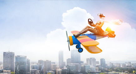 Woman in retro airplane . Mixed media