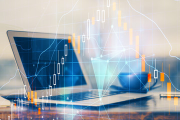 Stock market graph and table with computer background. Multi exposure. Concept of financial analysis.