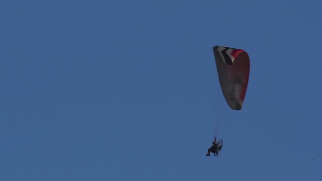 man flying parafly motorized blue sky