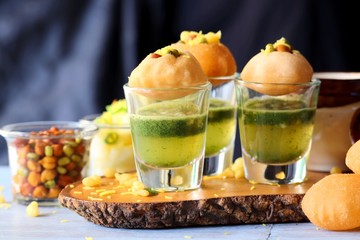 Pani Puri shots, Indian street snack made of fried puries, mint chutney, sprouts and boiled potatoes. Indian Chat