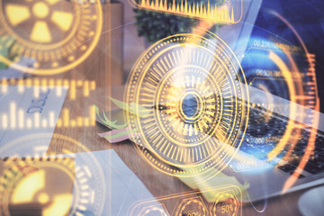 Computer on desktop in office with technology theme hologram. Multi exposure. Tech concept.