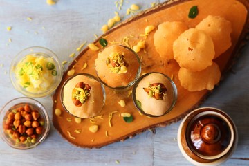 Pani Puri shots, Indian street snack made of fried puries, mint chutney, sprouts and boiled potatoes. Indian Chat