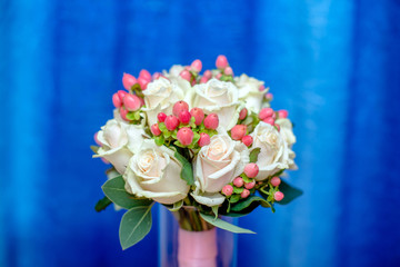 Wedding bouquet of roses on a blue background
