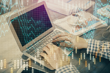 Double exposure of forex graph with man working on computer on background. Concept of market analysis.