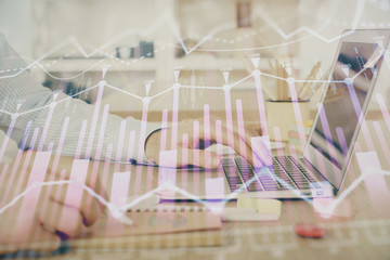 Multi exposure of stock market graph with man working on laptop on background. Concept of financial analysis.