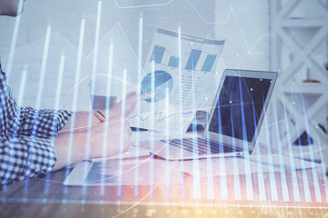Multi exposure of financial graph with man works in office on background. Concept of analysis.