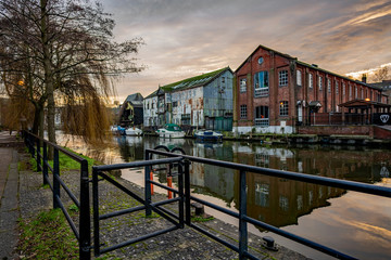 The industrial riverside area of Norwich and the waterfront industrial units and boats moored up...