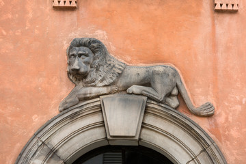 Fototapeta na wymiar Stone lion relief above the entrance to an old tenement house, old town, Warsaw, Poland