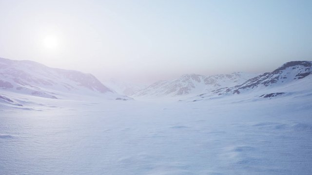 Aerial Landscape of snowy mountains and icy shores in Antarctica