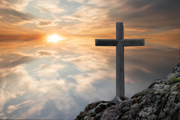 The cross of the crucifixion of Jesus Christ has a sacred sunset background.