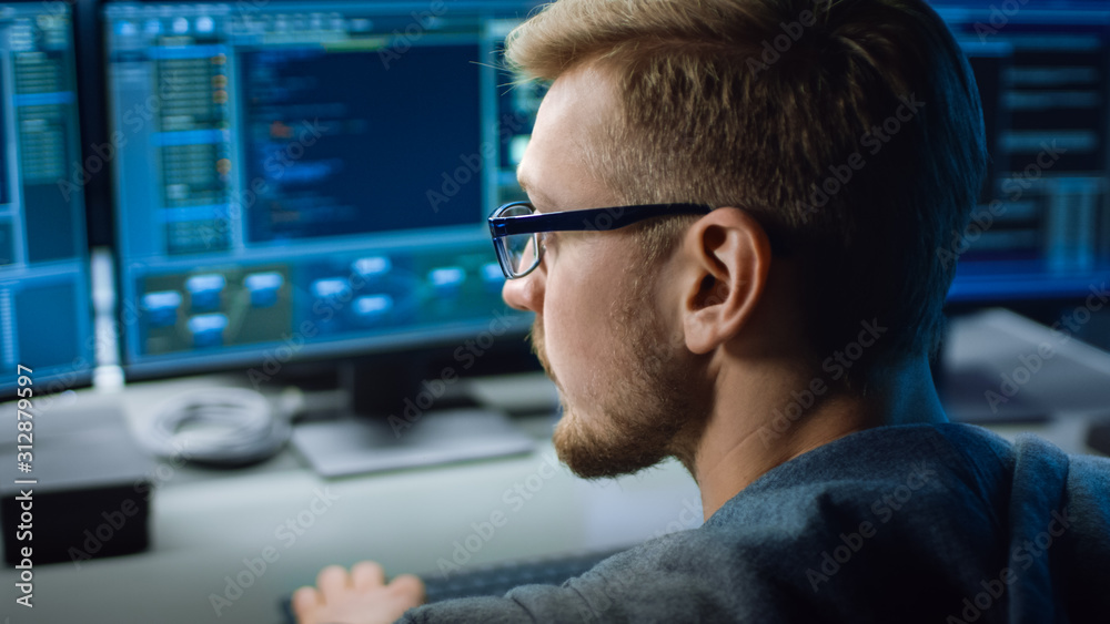 Poster IT Specialist Works on Personal Computer with Screens Showing Software Program with Coding Language Interface. In the Background Technical Room of Data Center with Professional Working