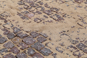Construction materials in a construction site. In this photo you can see brown sand and red stone material used to create a walkway in Finland. Closeup color image with beautiful textures.