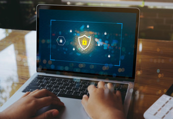 Person using a Laptop Computer with data protection, Cyber security, information safety and encryption concept. internet technology and business concept, Laptop mockup with clipping path on screen.