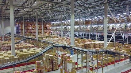 Huge automated warehouse with moving boxes on a conveyor belt - Powered by Adobe