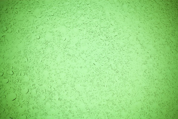 Rain droplets on green glass background, Water drops on green glass.