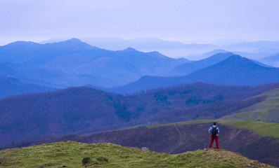 Mountaineer on Mount Bunaniarri with the Gipuzkoa Mountains in the background