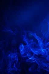 Blue smoke on black background.