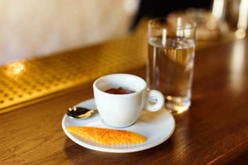 Minsk, Belarus - 03.19.2018: a cup of ILLY brand espresso, garnished with an orange peel covered...