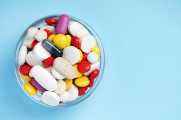A bowl with colorful medicine pills