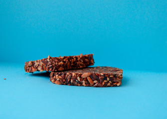 Sliced whole grain bread rye with seeds flax, sunflower, pumpkin and sesame.Healthy food, eco-friendly natural products. Fresh bread on a blue background.