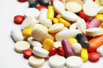 Different colorful tablets at white background
