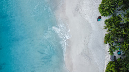 Aerial view of beautiful island at Seychelles in the Indian Ocean. Top view from drone. Spectacular aerial view of some yachts and small boats floating on a clear and turquoise sea, Seychelles in the 