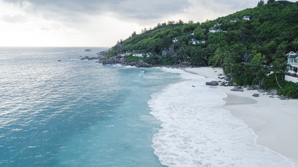 Aerial view of beautiful island at Seychelles in the Indian Ocean. Top view from drone. Spectacular aerial view of some yachts and small boats floating on a clear and turquoise sea, Seychelles in the 